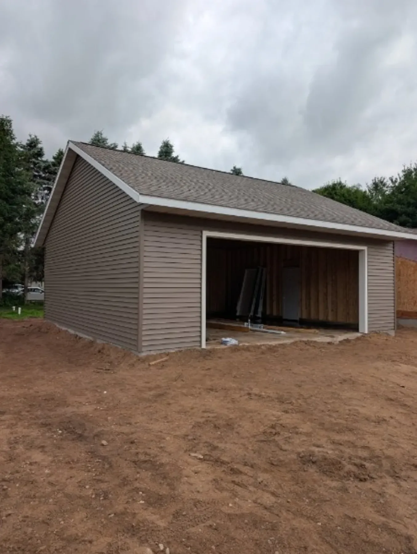 Front 3/4 view of 28x28 brown vinyl garage, Chippewa Valley WI