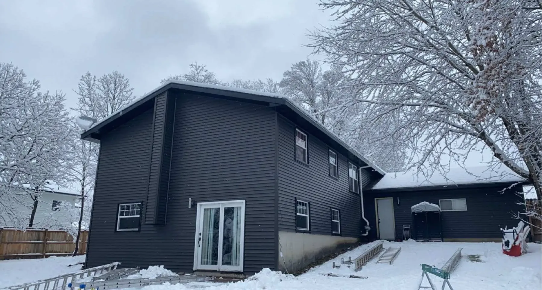 Completed charcoal lap siding on two-story house, Chippewa Valley WI
